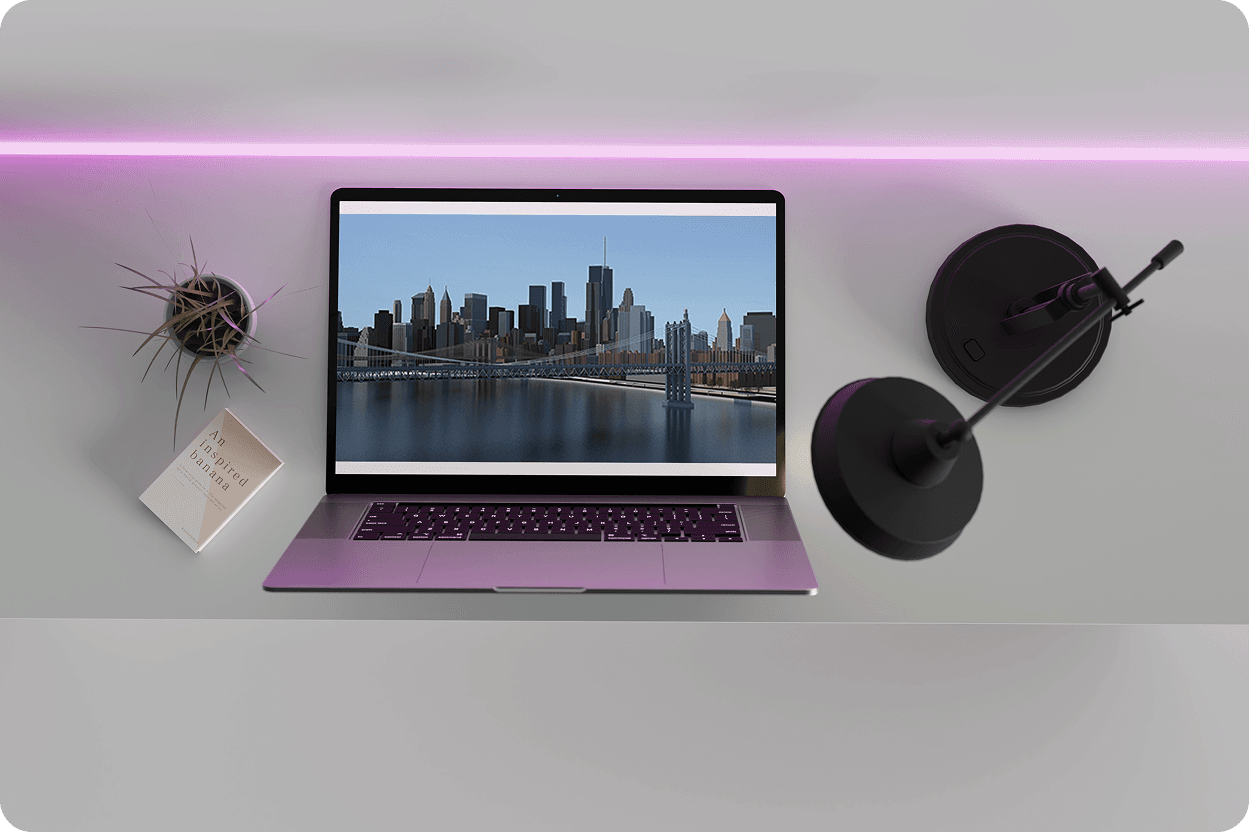 Overhead laptop on white desk showing aerial 3D Manhattan-style city render